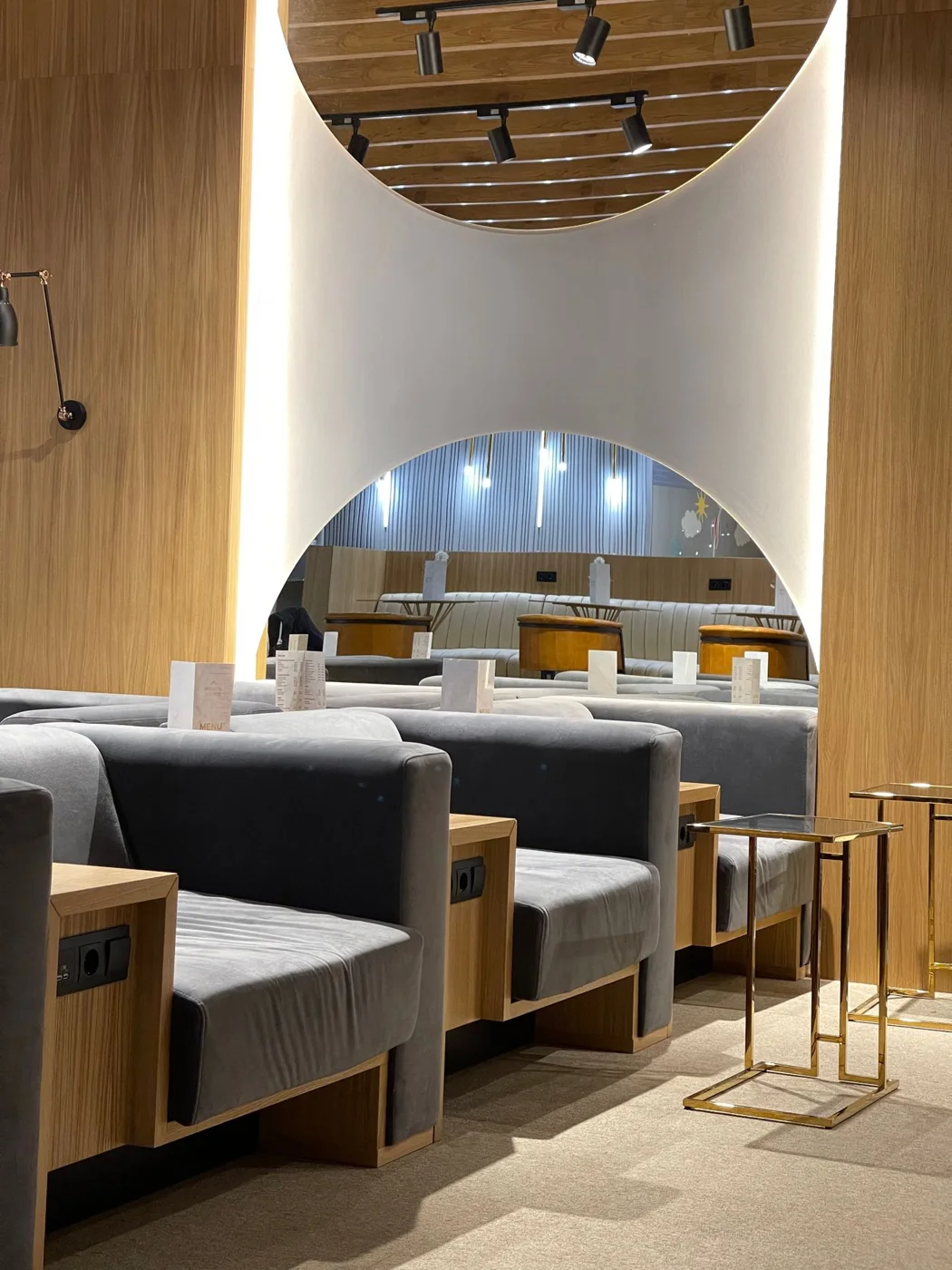 A contemporary lounge with warm wood and soft seating