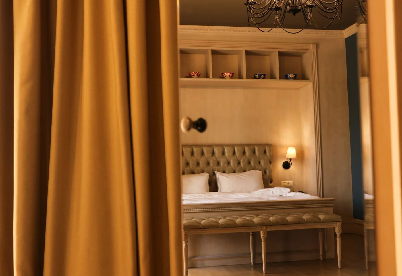 A warmly lit luxury hotel guest room